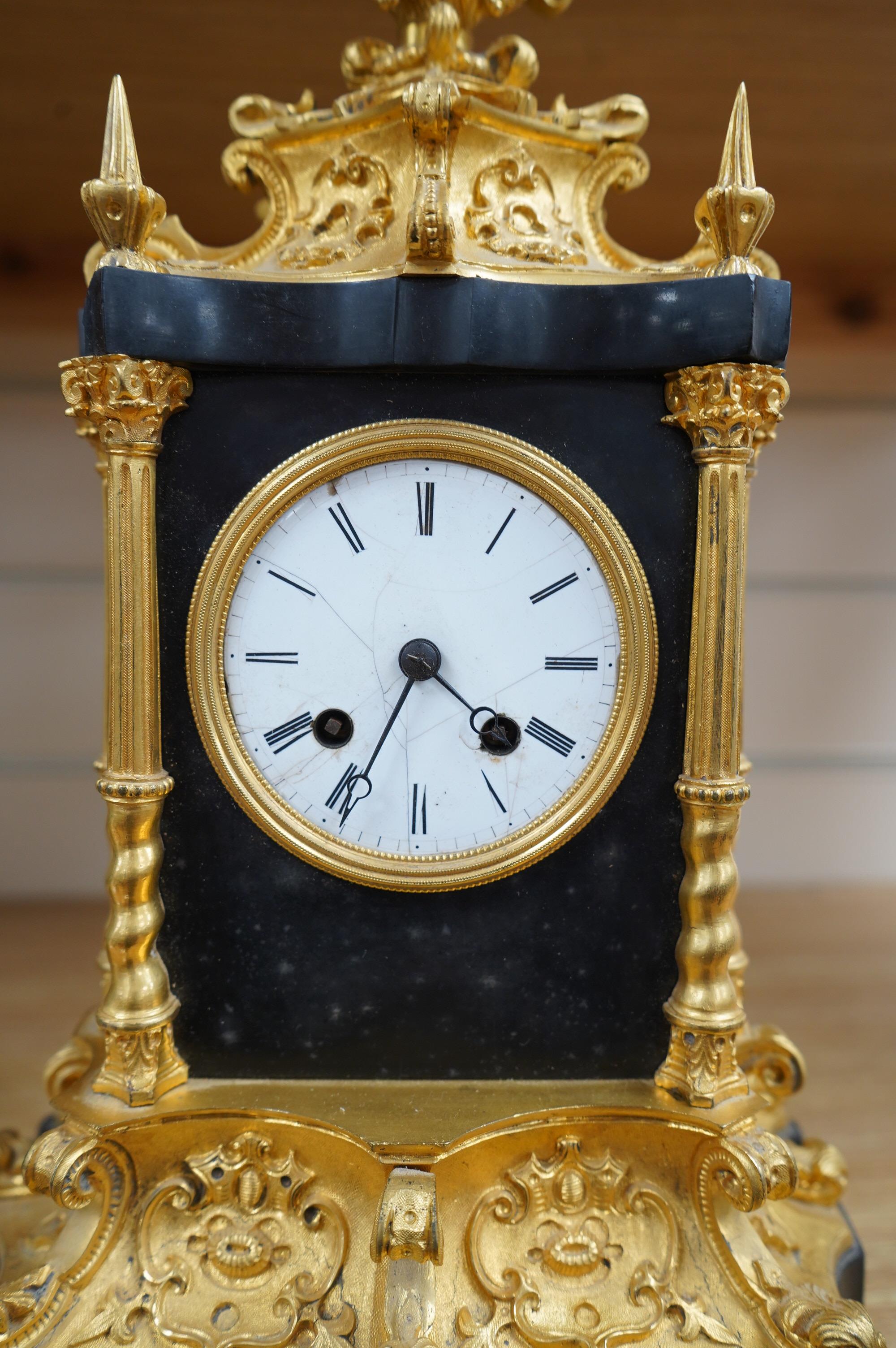 A French ormolu and slate mantle clock with a silk suspension movement, 33cm high. Condition - fair, cracks to the enamel dial.